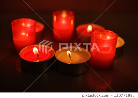 New Year's candles in Christmas trees with beautiful sides in the background in the New Year and Christmas 120771983