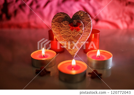 Illuminated tealight candles and red heart 120772043