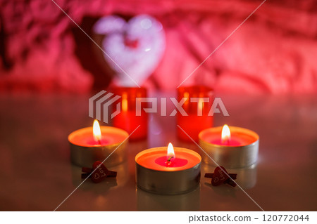 Illuminated tealight candles and red heart Illuminated tealight candles and red heart 120772044