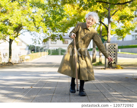 Senior woman leaning on a walking stick and about to fall 120772092