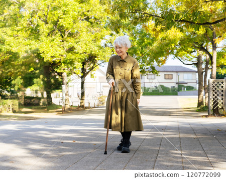 Senior woman walking with a cane Senior woman walking with a cane 120772099