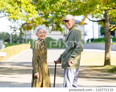 Senior couple: man with a cane and woman assisting him Senior couple: man with a cane and woman assisting him 120772110