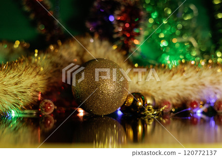 Christmas background with fir twigs, red berries, cones and Xmas lights on dark 120772137