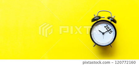 2025 and 2024 on black alarm clock on yellow background 2025 and 2024 on black alarm clock on yellow background 120772160
