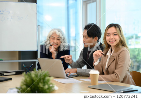 Professional businesspeople analyzing financial data on laptop and planning work at meeting 120772241