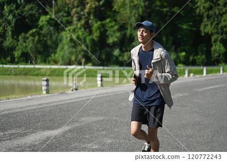 Shot of active man jogging outdoors on a sunny day Shot of active man jogging outdoors on a sunny day 120772243