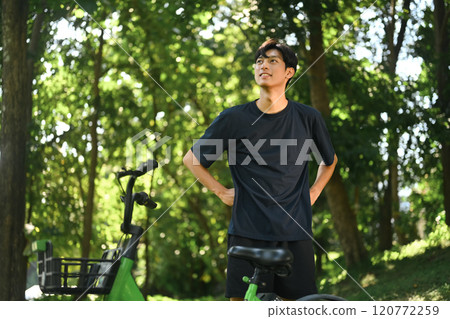 Handsome man relaxing and breathing fresh air outdoors after a bike ride Handsome man relaxing and breathing fresh air outdoors after a bike ride 120772259