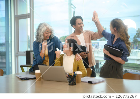 Group of excited businesspeople celebrating their successful project in the office 120772267