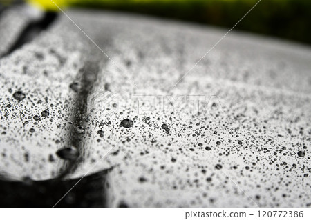 Raindrops on the bonnet of a car 120772386