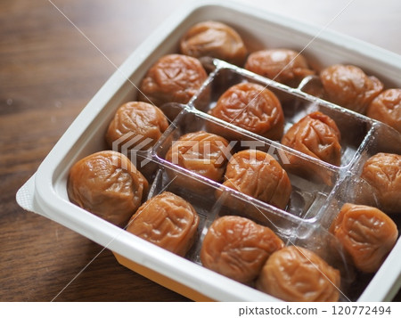 A pack filled with large pickled plums 120772494