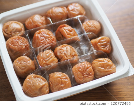 A pack filled with large pickled plums 120772495