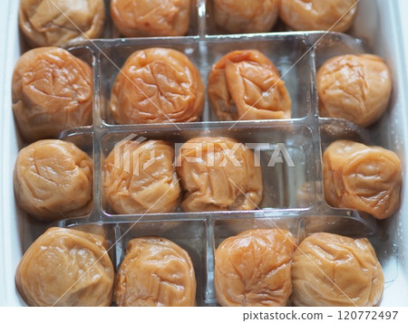 A pack filled with large pickled plums 120772497