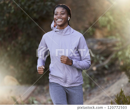 Black woman, running and outdoor for exercise, training or fitness for health, wellness or smile. Jamaican female, healthy athlete or runner in nature, workout or practice for power, energy or cardio 120772503