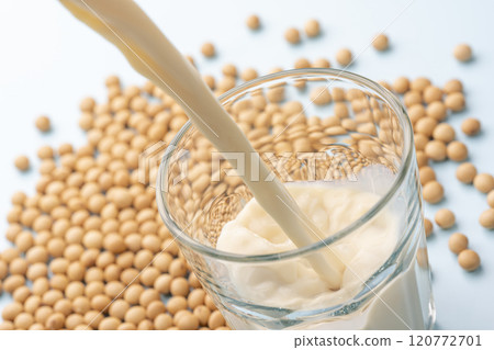 The moment soy milk is poured into a glass and soybeans 120772701