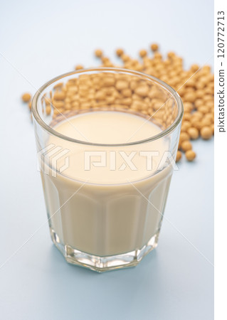 Glass cup with soybeans and soy milk on a light blue background 120772713