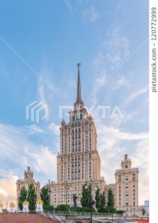 high-rise stalinist building near river at summer sunset in Moscow, Russia. Historic name is Hotel Ukraine. high-rise stalinist building near river at summer sunset in Moscow, Russia. Historic name is Hotel Ukraine. 120772999