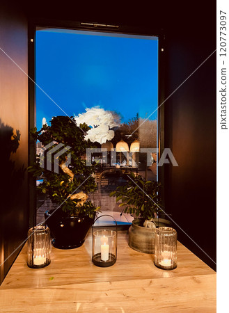 Interior of a modern cafe in the evening with candles and plants in asian style 120773097
