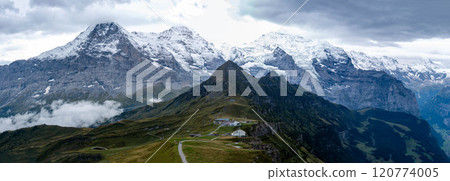 View of the three peaks of the Jungfrau over the Tschuggen mountain from the top of Männlichen, Grindelwald, Switzerland View of the three peaks of the Jungfrau over the Tschuggen mountain from the top of Männlichen, Grindelwald, Switzerland 120774005