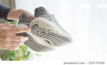 A woman with the outside of her soles worn down 120774509