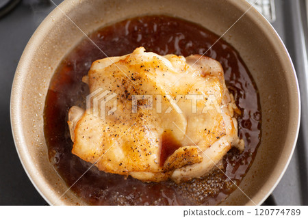 Cook teriyaki chicken steaks in a frying pan 120774789