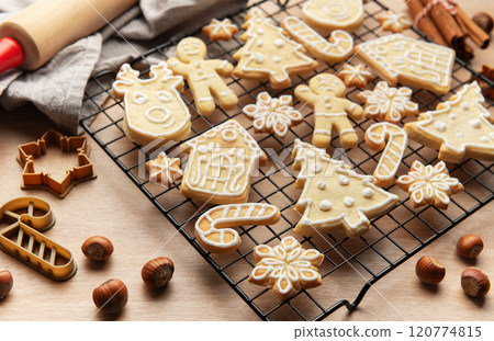 Christmas cookies cooling on rack with festive shapes and decorations, Christmas cookies cooling on rack with festive shapes and decorations, 120774815