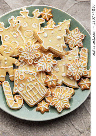 Christmas cookies with white icing forming various shapes lying on a plate Christmas cookies with white icing forming various shapes lying on a plate 120774816