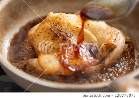 Cook teriyaki chicken steaks in a frying pan 120775073