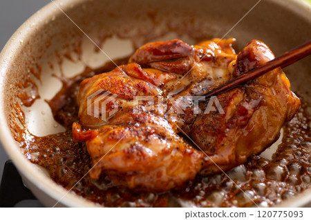 Cook teriyaki chicken steaks in a frying pan 120775093