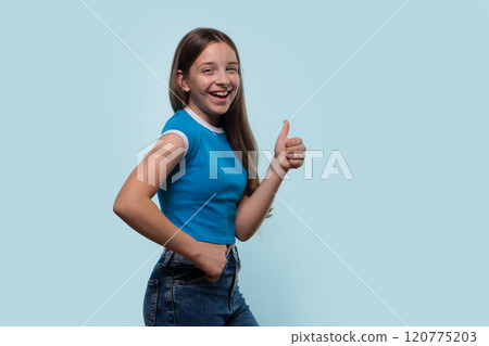 Young girl smiling and giving thumbs-up after vaccination. 120775203