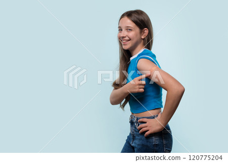 Young girl pointing at bandage on arm after vaccination 120775204