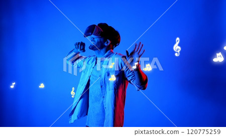 Dancer wearing VR glasses and moving to song with music note float. Apparatus. Dancer wearing VR glasses and moving to song with music note float. Apparatus. 120775259