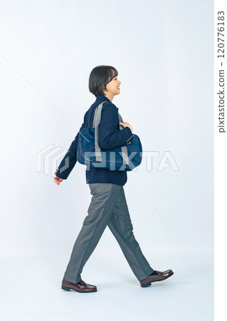Full-body photo of a female student wearing a walking genderless uniform 120776183