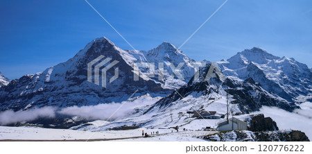 View of the three peaks of Jungfrau from the Mannliffen trekking trail, Grindelwald, Switzerland View of the three peaks of Jungfrau from the Mannliffen trekking trail, Grindelwald, Switzerland 120776222