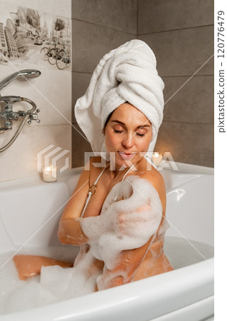 Pregnant Woman Bathing with Candles 120776479