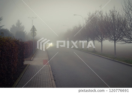 Bad weather driving - foggy hazy country road. Motorway - road traffic. Winter time. Bad weather driving - foggy hazy country road. Motorway - road traffic. Winter time. 120776691