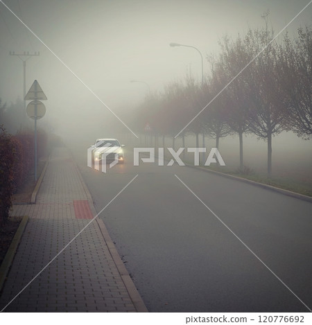 Bad weather driving - foggy hazy country road. Motorway - road traffic. Winter time. Bad weather driving - foggy hazy country road. Motorway - road traffic. Winter time. 120776692