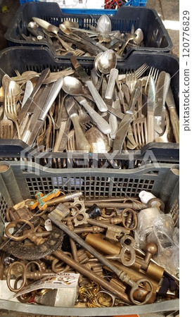 Selective focus vintage keys and cutlery inside old boxes at flea market in Athens. Garage sale of antique items 120776829