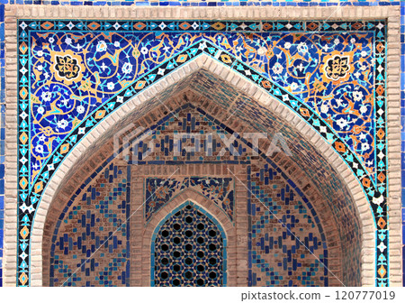 Decorative arch in Sher-dor Madrassah, Registan, Samarkand, Uzbekistan. Detail of arch with tile decor, Sher Dor (Lion) Medressa, part of Registan Ensemble 120777019