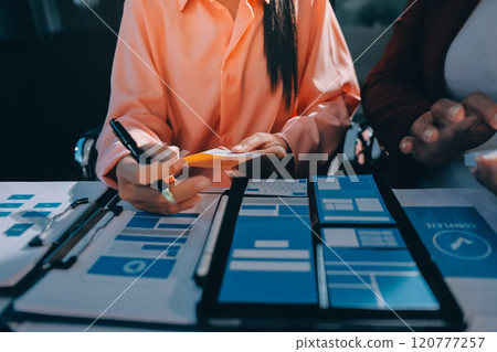 Young Asian business creative team work together, mobile application software design project. Brainstorm meeting, internet technology, smartphone web app designer, office coworker teamwork concept Young Asian business creative team work together, mobile application software design project. Brainstorm meeting, internet technology, smartphone web app designer, office coworker teamwork concept 120777257