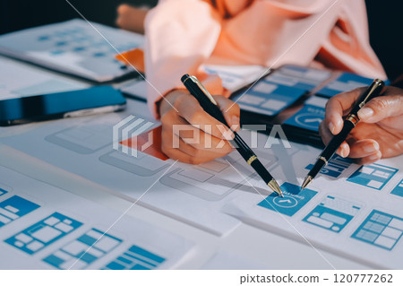 Young Asian business creative team work together, mobile application software design project. Brainstorm meeting, internet technology, smartphone web app designer, office coworker teamwork concept Young Asian business creative team work together, mobile application software design project. Brainstorm meeting, internet technology, smartphone web app designer, office coworker teamwork concept 120777262