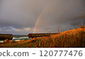 A rainbow seen from the coastline 120777476