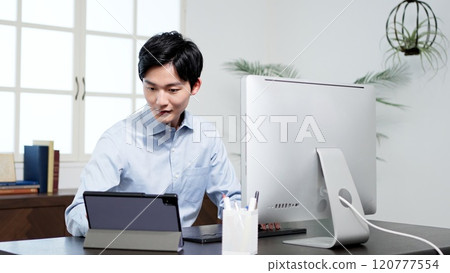 Businessman working on a computer in the office Businessman working on a computer in the office 120777554