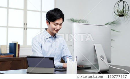 Businessman working on a computer in the office Businessman working on a computer in the office 120777557