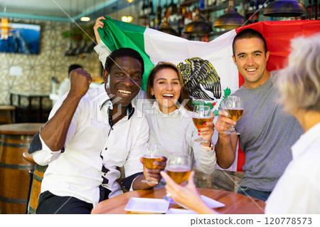 Diverse group celebrating with Mexican flag 120778573