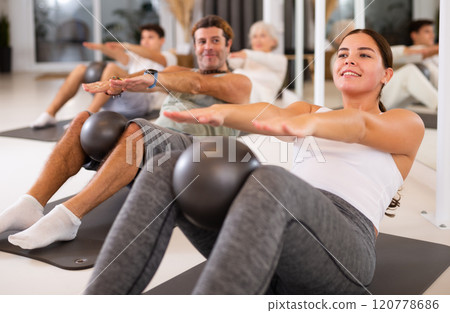 Young woman doing pilates with ball Young woman doing pilates with ball 120778686