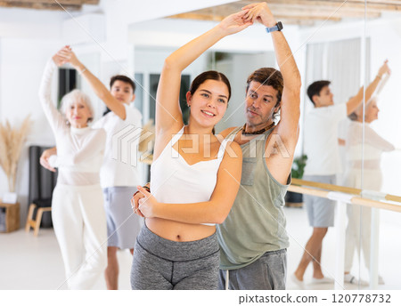 Young woman and adult man dancing as couple 120778732