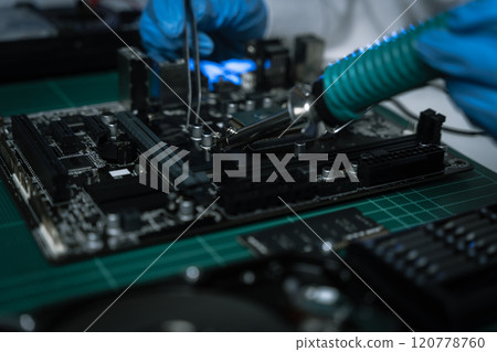 killed hands repairing electronic devices with precision. technology repair, technician expertise, and modern electronic maintenance. 120778760