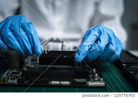 killed hands repairing electronic devices with precision. technology repair, technician expertise, and modern electronic maintenance. 120778763
