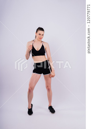 Weightloss, health and woman with measuring tape in a studio for her diet, exercise or wellness. Weightloss, health and woman with measuring tape in a studio for her diet, exercise or wellness. 120779771