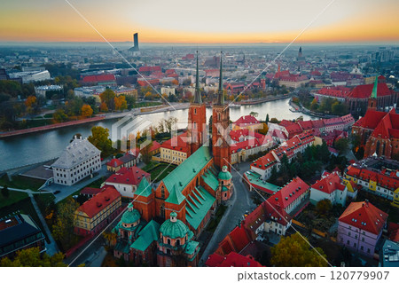 Aerial view of European city with Gothic churches and historic architecture in autumn season. St. John Cathedral on Ostrow Tumski at sunset. Cityscape panorama of Wroclaw, Poland 120779907
